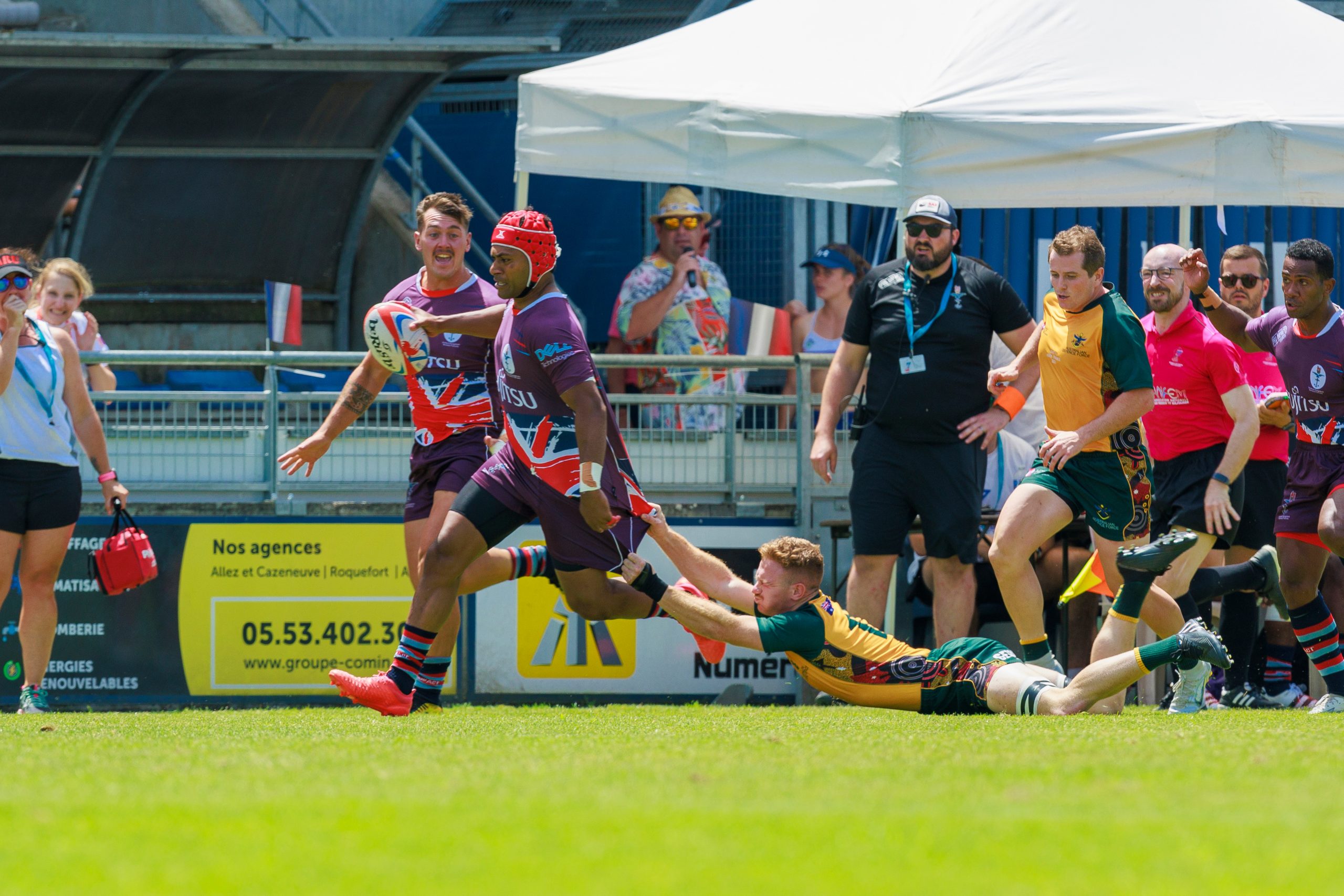 men's 7s. UKAF Player breaks though an Australian Defence Force tackle